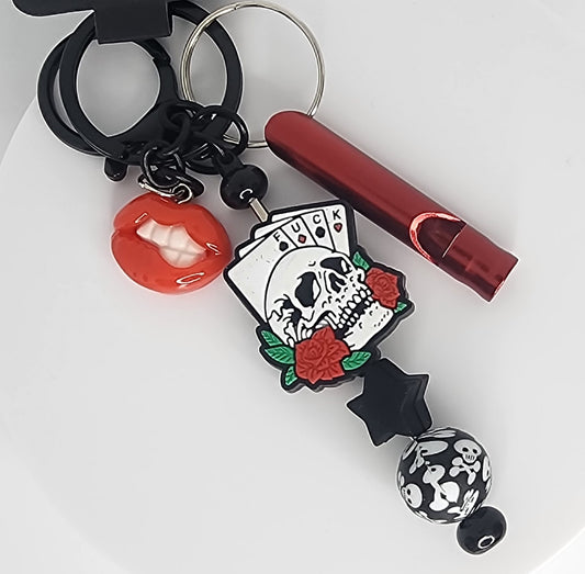 Keychain with skull and card design on a white background