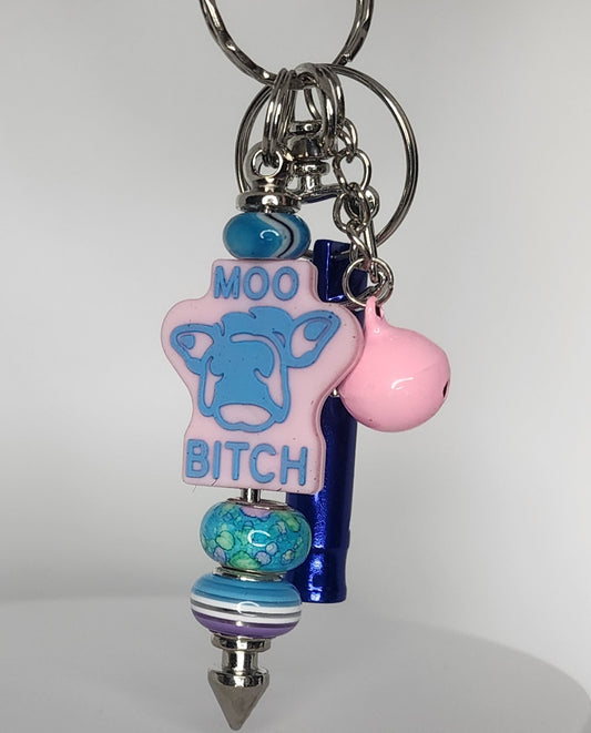 Keychain with colorful beads and a cow-shaped tag on a white background